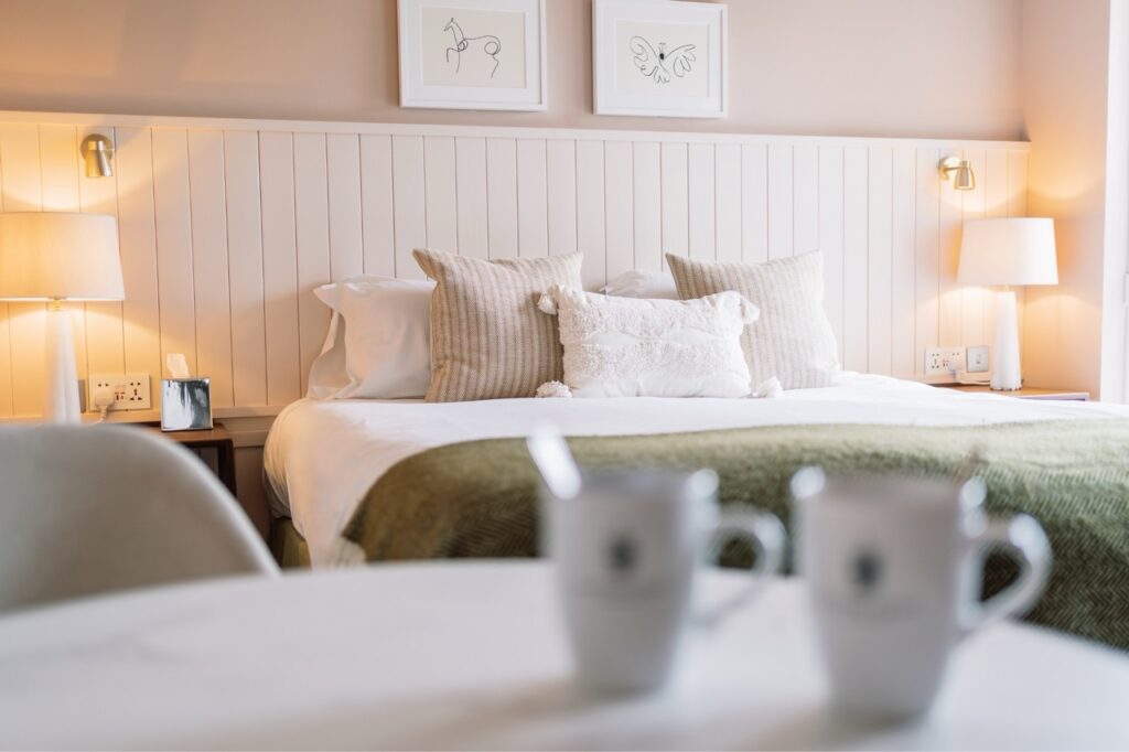 King Size bed with cushions and pillows in a newly refurbished heritage room at hatton court hotel