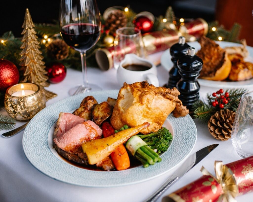 Roast beef being served on Christmas Day at hatton court hotel with christmas decorations on the table