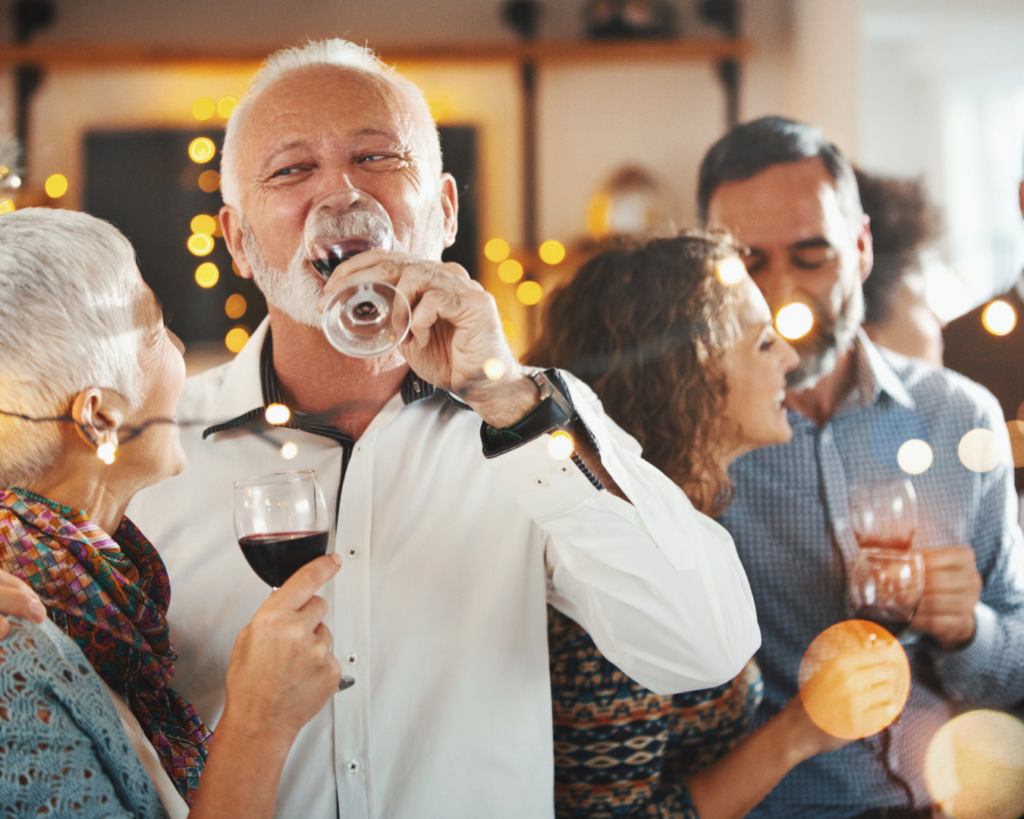 Older guests enjoying a festive drink while at a dinner party at hatton court hotel